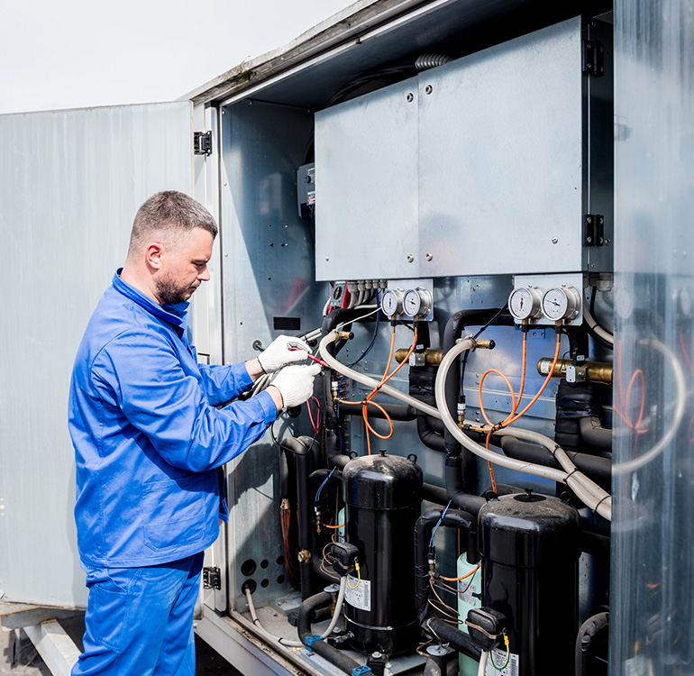 Technician servicing HVAC system
